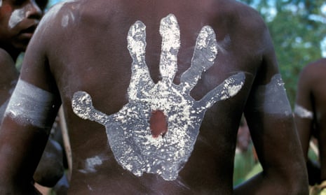 Body of Indigenous person painted with a hand
