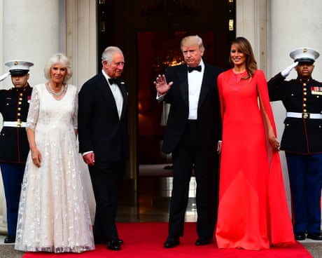 Donald Trump waves as he stands next to the then the Prince of Wales and Duchess of Cornwall