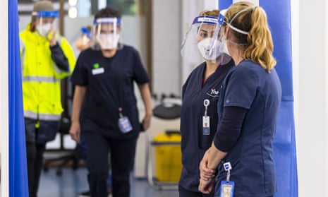 Health care workers are seen in the COVID vaccination hub in hospital.