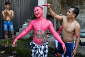 Young man having his body and face painted to attend a sacred ritual