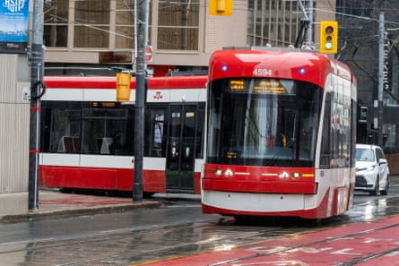 A red and white Toronto streetcar turns at Richmond St