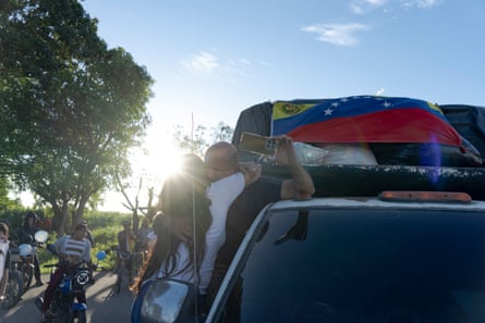 A woman hugs Silvio Sivira during the arrival of the 18 volunteers