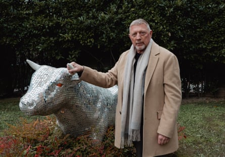 Boris Becker posing with a model cow