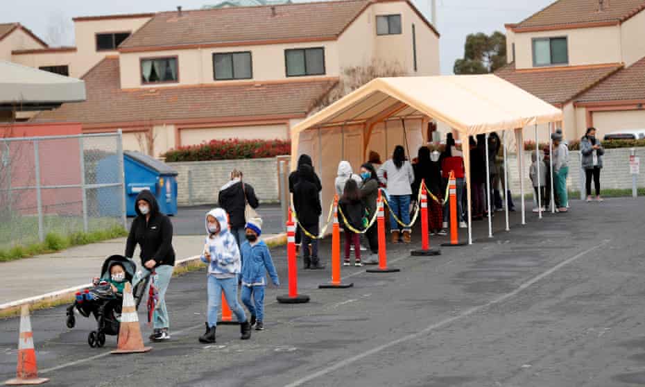 Parents with their children wait in line to be tested for Covid-19 at Ohlone elementary school in Hercules, California, in January, at the height of the Omicron wave.