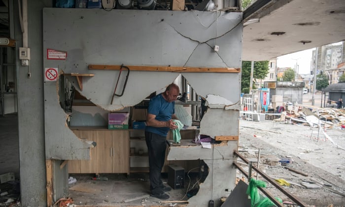 People sort things in their destroyed stores in damaged civil infrastructure building at the site of a Russian cruise missile strike in Vinnytsia, Ukraine July 15, 2022.