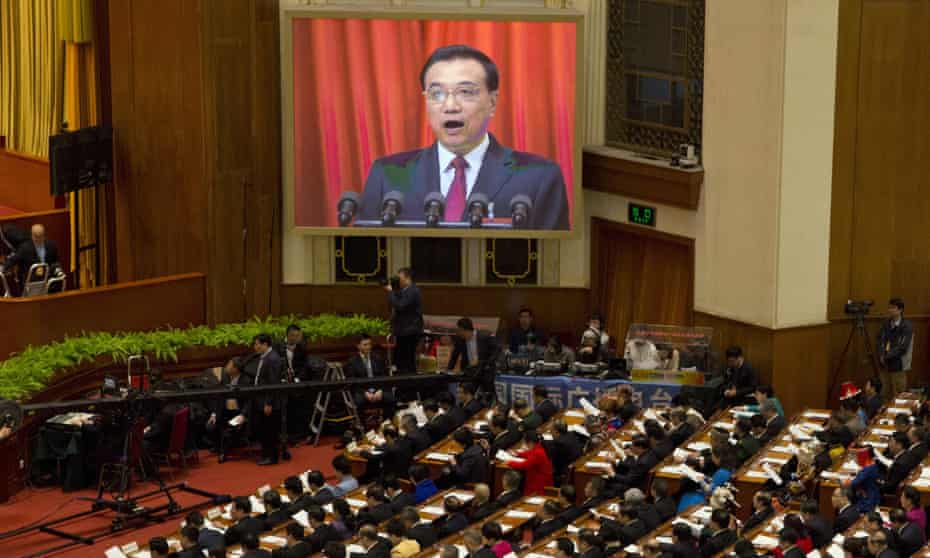 Chinese Premier Li Keqiang is displayed on a huge screen as he delivers a work report at the opening session of the annual National People’s Congress at Beijing’s Great Hall of the People, Sunday, March 5, 2017.China’s top leadership as well as thousands of delegates from around the country are gathered at the Chinese capital for the annual legislature meetings. (AP Photo/Ng Han Guan)