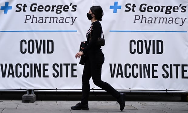 A pedestrian walks past a Covid vaccination centre in London.