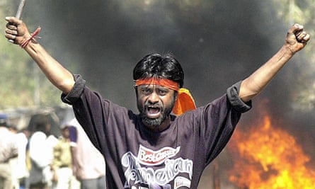 An activist armed with a iron stick shouts slogans