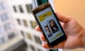 A person holds a phone with a dating app on the screen that shows two personal profiles and the heading 'dates' on a yellow background