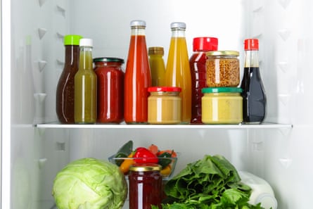 A collection of sauces on a fridge shelf