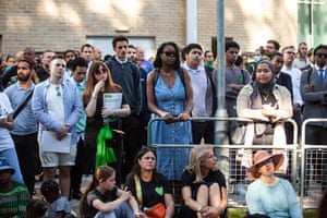 People attend the memorial service outside Grenfell Tower in London