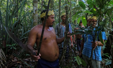 Sateré-Mawé men collect medicinal herbs to treat people showing Covid symptoms, in a rural area west of Manaus, Brazil.