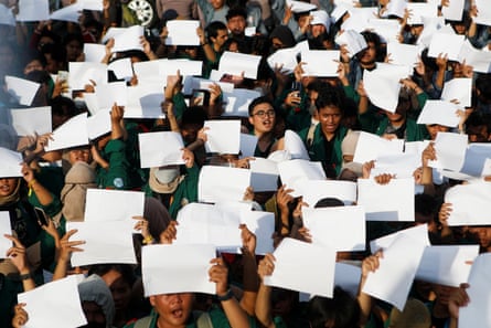 University students raise white sheets of paper during a protest in Jakarta against ‘sex morality’ laws.