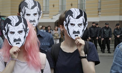 People wearing a mask of Big Brother from 1984 at a protest rally for freedom on the internet in St Petersburg.