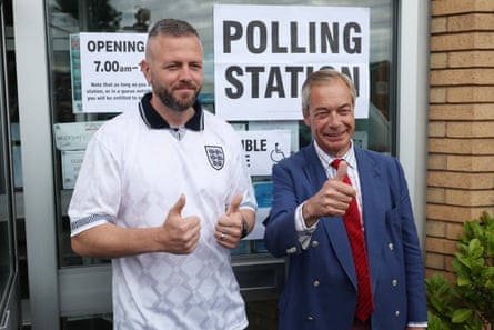 Robert Kenyon does a thumbs up with Nigel Farage in Wigan at a polling station