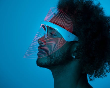 A man using an LED therapy mask at home.