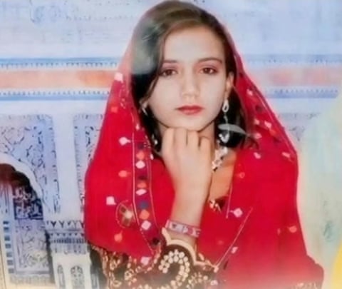 A young woman wearing a red sari. dqxikeidqkihxinv