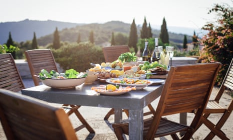 A typical outdoor Mediterranean meal, with Tuscany, landscape in the background