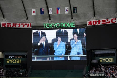 Japanese Emperor Naruhito, Princess Aiko and Empress Masako are seen on the screen after Sunday’s game.