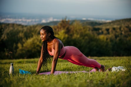 Young woman doing a plank exercise outdoors