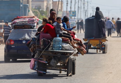 Palestinians travel in an animal-drawn cart as they flee Rafah after Israeli forces launched a ground and air operation in the eastern part of the southern Gaza city.