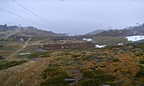 An image from Thredbo’s snow cam showing the Basin ski run with a few patches of snow at the start of the Australian ski season.