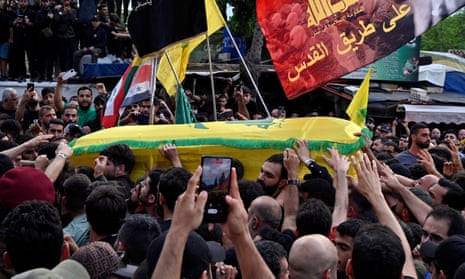 Mourners carry the coffin of Hezbollah commander Ibrahim Akil during his funeral procession in Beirut on Sunday