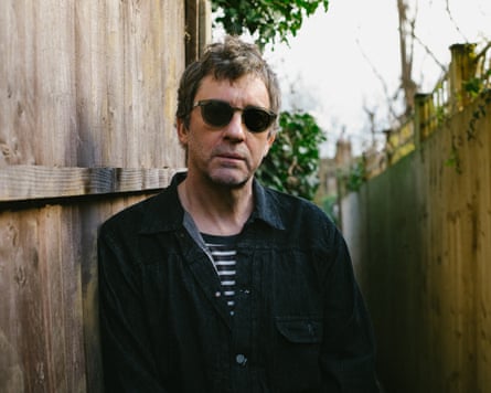 Graham Coxon of Blur by a fence