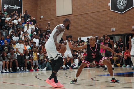 Dion Wright, in black, defends LeBron James, in white, at the Drew league in Los Angeles in the summer of 2022.