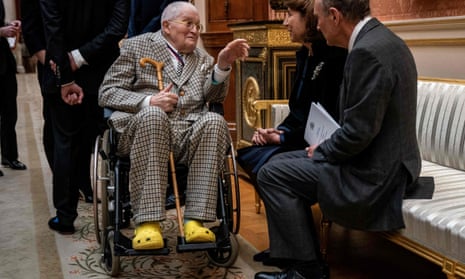 David Hockney, in yellow Crocs,  talks with attendees at the Order of Merit lunch at Buckingham Palace on Thursday