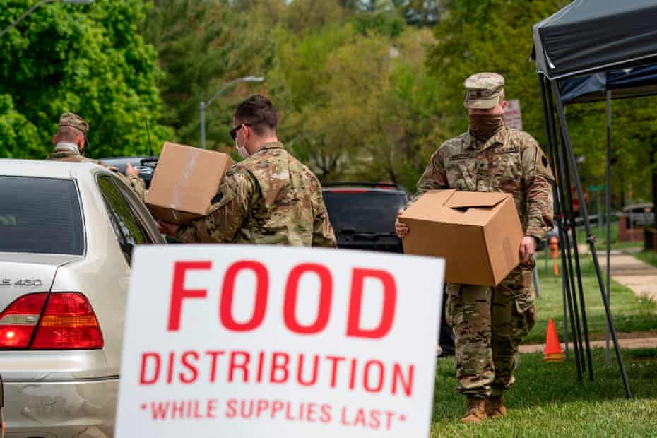 Soldiers with the Maryland Army National Guard distribute food to those in need in Windsor Mill, Maryland.
