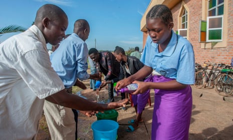 People wash their hands as a preventive measure against the spread of coronavirus on the last day that church gatherings were allowed, at a parish in Lilongwe on 22 March.