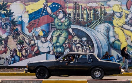A mural of workers marching up oil pipelines holding on their shoulders a woman waving the Venezuelan flag.