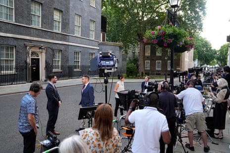 Journalists broadcasting from Downing Street.