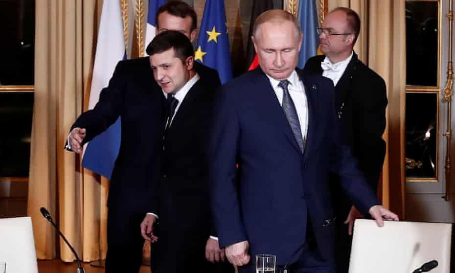 Volodymyr Zelenskiy and Vladimir Putin at the Élysée Palace, the two did not shake hands or acknowledge each other at a press conference after the meeting.