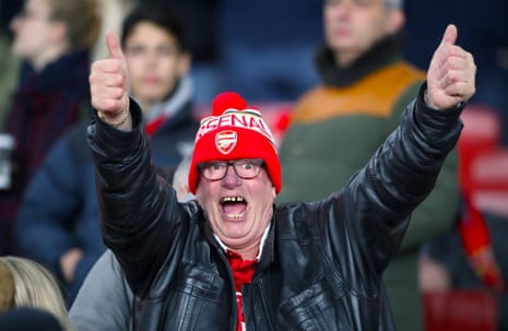 This Arsenal fan is pleased to be in the stands at the Emirates Stadium.