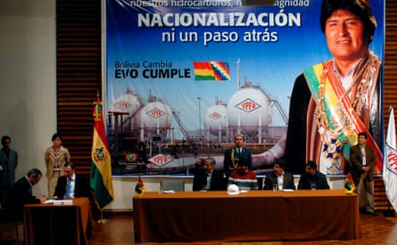 A BP official signs an agreement with Bolivian government representatives, October 2006.