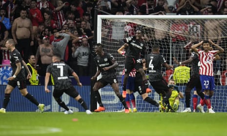Bayer Leverkusen's players celebrate after their goalkeeper Lukas Hradecky saved a penalty against Atletico Madrid.