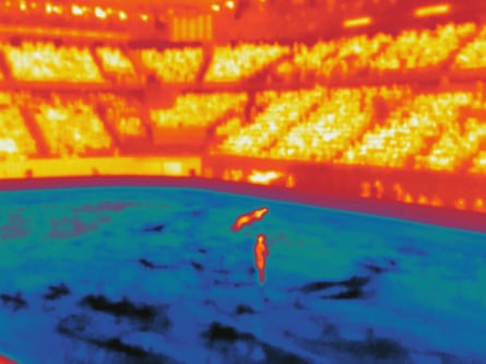 Athletes compete in the pairs skating short programme at Milano Ice Skating Arena.