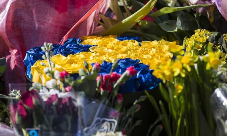 A floral decoration designed in the colours of the Swedish flag left to mark the deaths of four people in a lorry attack on Friday in Stockholm, Sweden