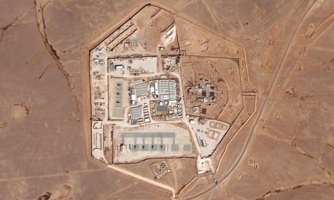 Aerial photo of a military base on tan, brown land.