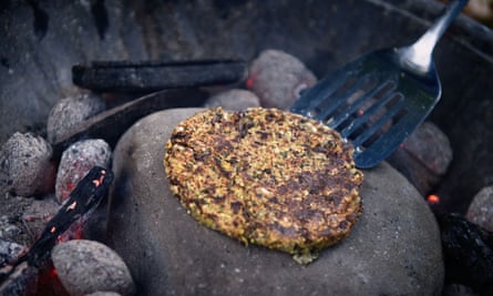 The pattie cooking on a hot rock