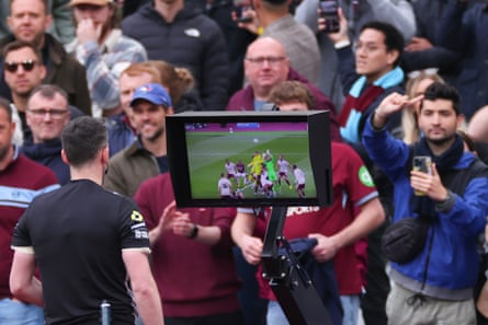 Referee Chris Kavanagh reviews VAR before disallowing a late goal from Callum Wilson at London Stadium