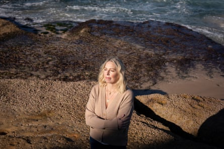 Hannah Richell standing in front of rocks on Tamarama Beach, Sydney, Australia, where her husband was killed in a surfing accident