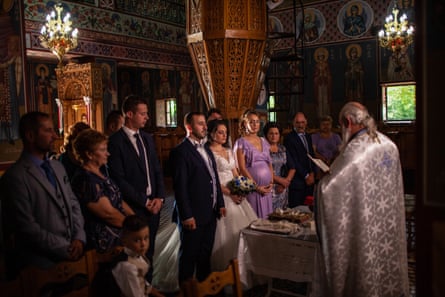 Kostas, Fotini and their families in church at their marriage ceremony