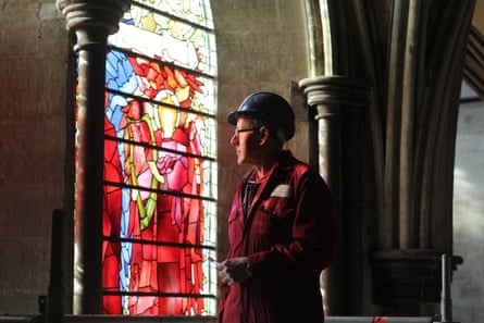 Sam Kelly, the head glazier, examined the windowin Salisbury Cathedral.