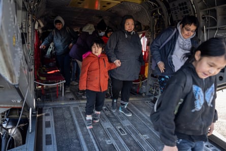 People walking off a ramp.