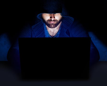 Man working at computer in dark room