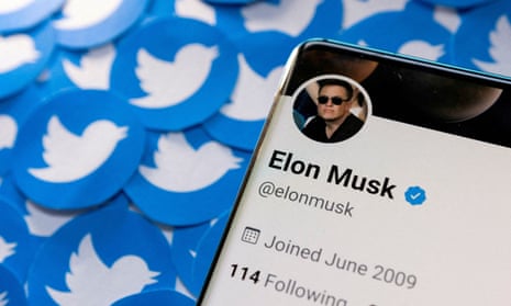Elon Musk's Twitter profile on smartphone and printed Twitter logos.