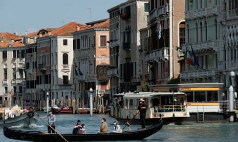 Gondoliers resume their service on the Grand Canal in Venice as Italy eases more lockdown measures.
